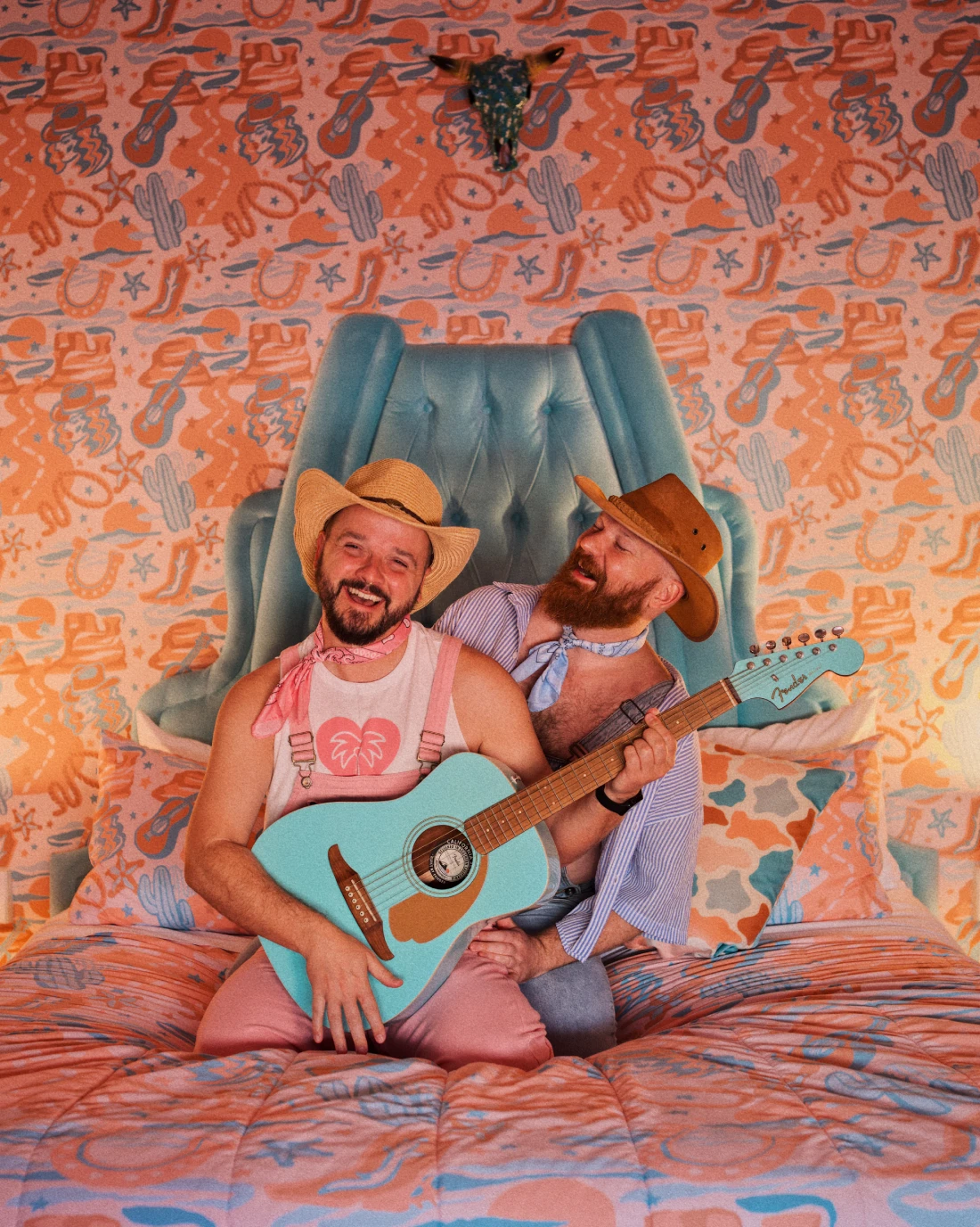 Gay Cowboys playing guitar at Yeehaw Cowgirl Suite at Trixie Motel &copy; Coupleofmen.com