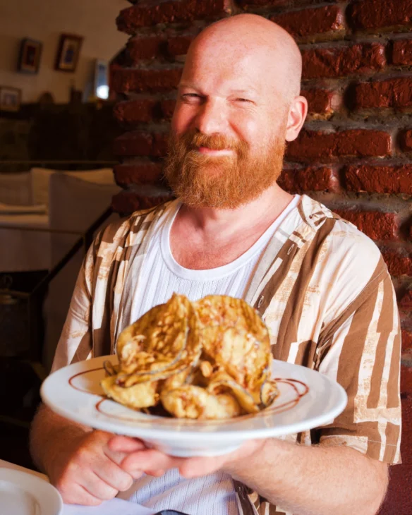 Daan enjoying his fried eggplant with local honey &copy; Coupleofmen.com