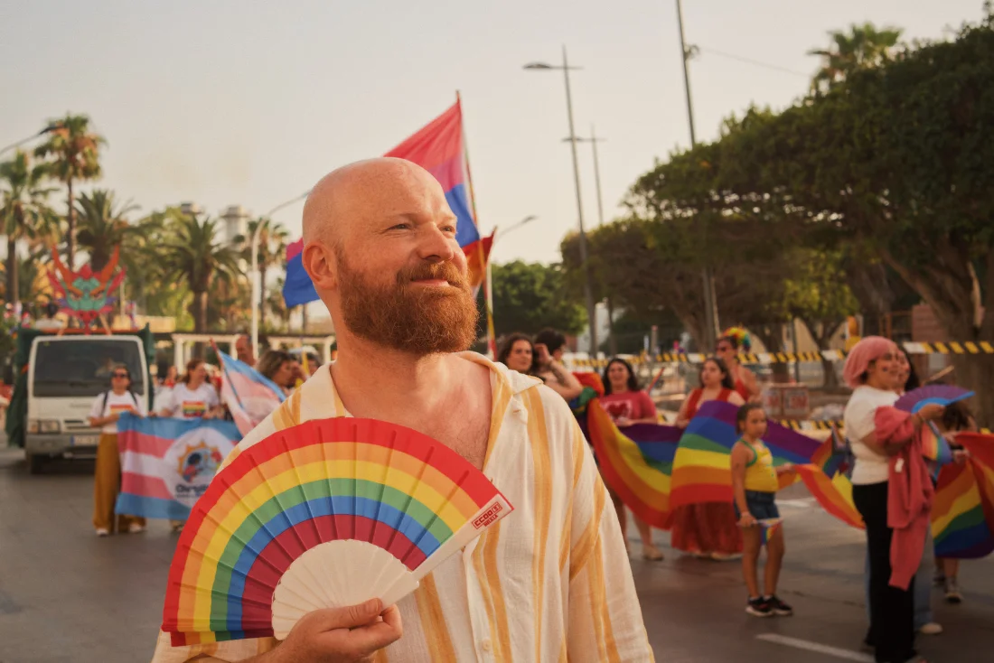 North Africa Pride in Melilla: Happy Daan with rainbow fan walking the Pride march &copy; Coupleofmen.com
