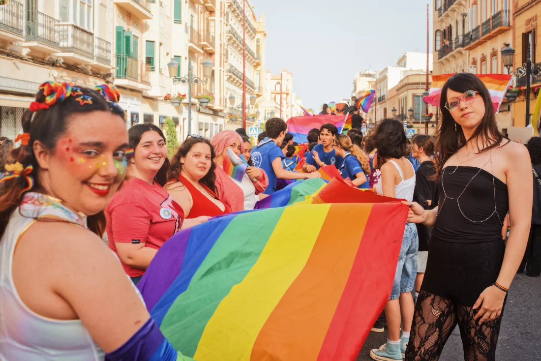 LGBTQ+ carrying a huge rainbow flag over the Avenida del Rey Juan Carlos I &copy; Coupleofmen.com