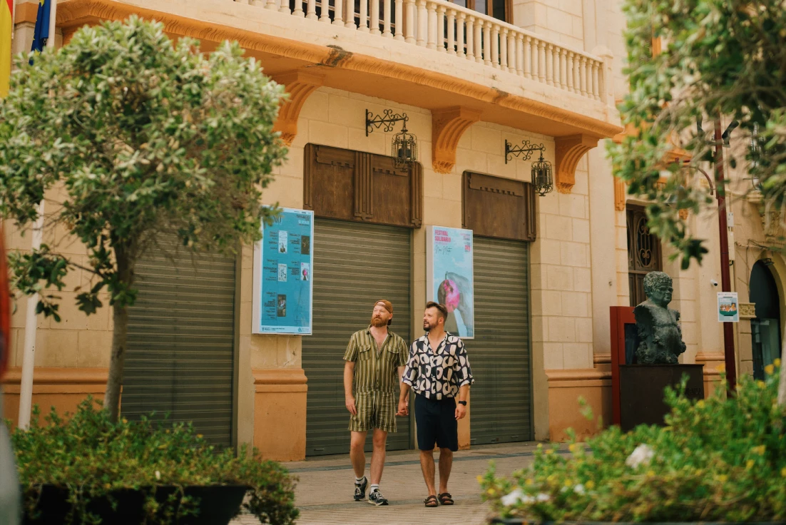 Travel moment in front of the beautiful building of Teatro Kursaal - Fernando Arrabal 1930 &copy; Coupleofmen.com
