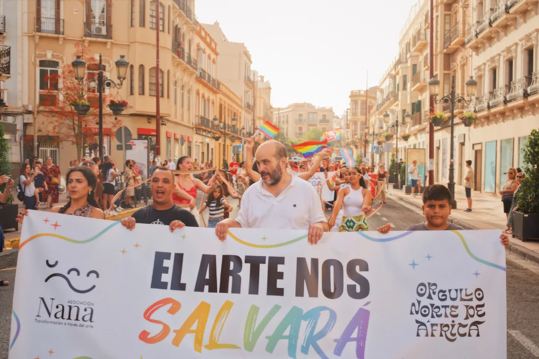 Participants at North Africa Pride in Melilla carrying an Asociaci&oacute;n Nana banner reading &ldquo;El arte nos salvar&aacute;&rdquo; on Avenida del Rey Juan Carlos I