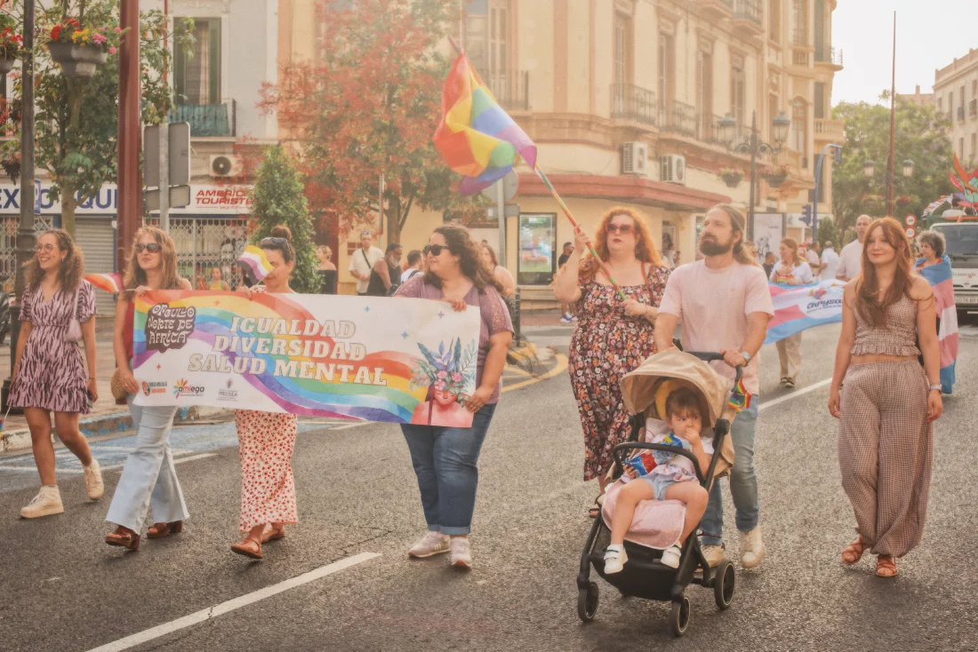 Pride marchers in Melilla carrying a rainbow banner reading &ldquo;Igualdad, diversidad, salud mental&rdquo; and waving LGBTQ+ flags during North Africa Pride