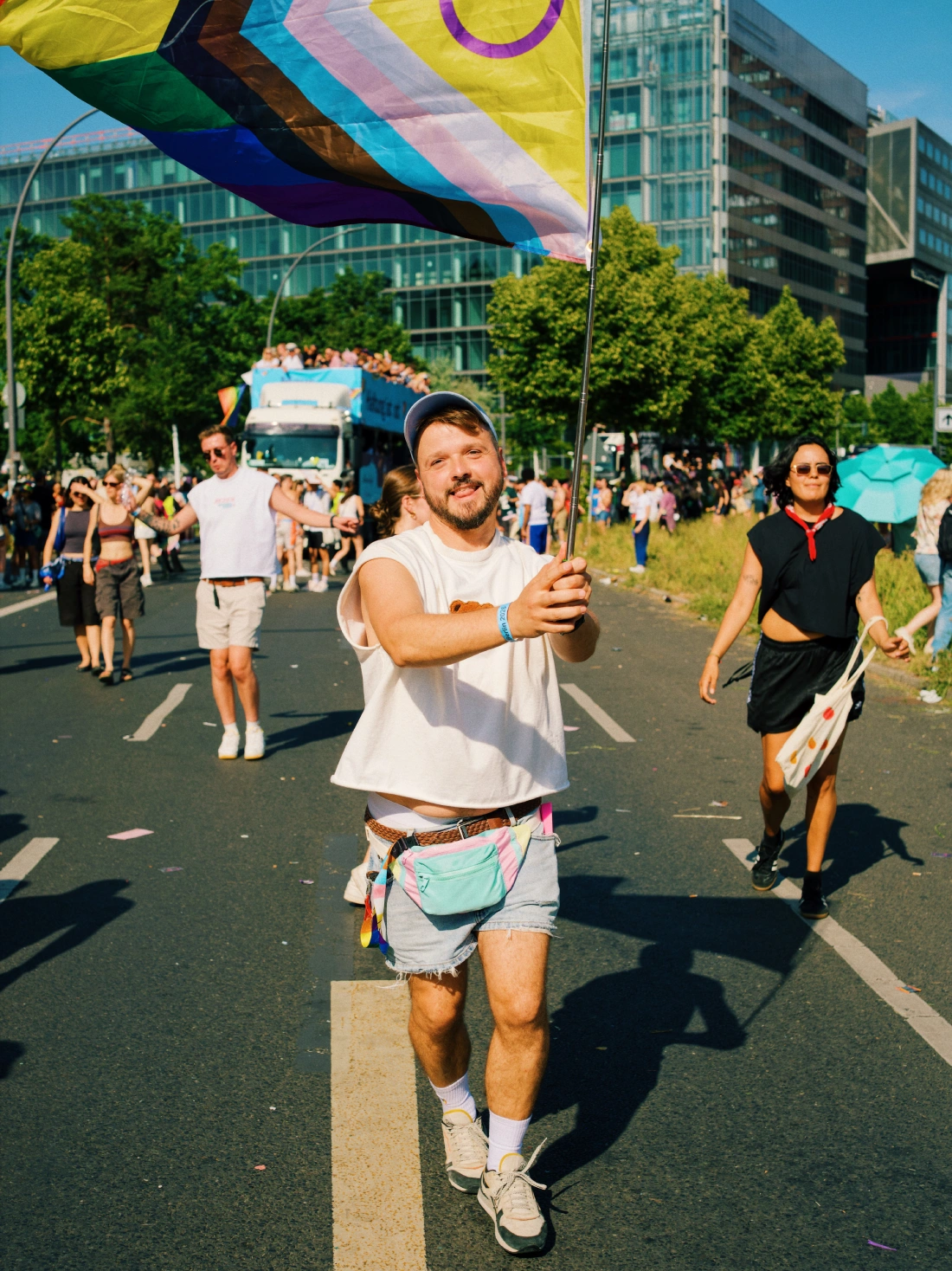 Karl proudly waving his Progress Pride flag on the streets of Berlin