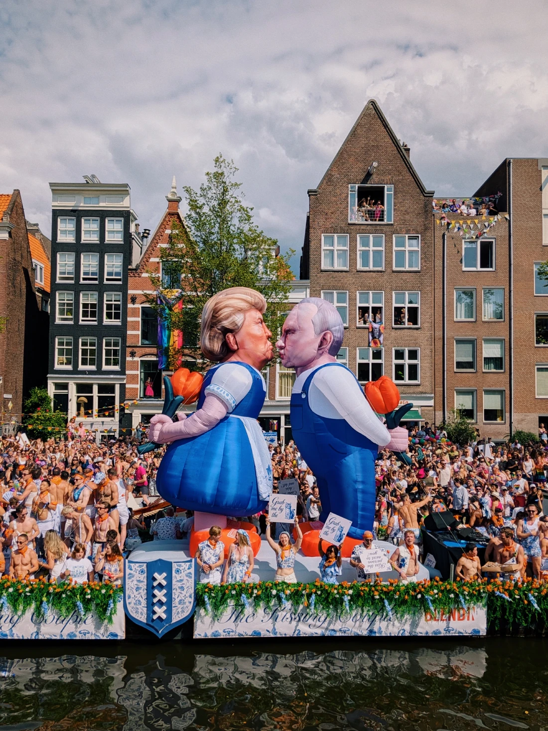 Trump and Putin kissing in traditional Dutch outfits during World Pride Canal Parade 2026 &copy;&nbsp;Coupleofmen.com