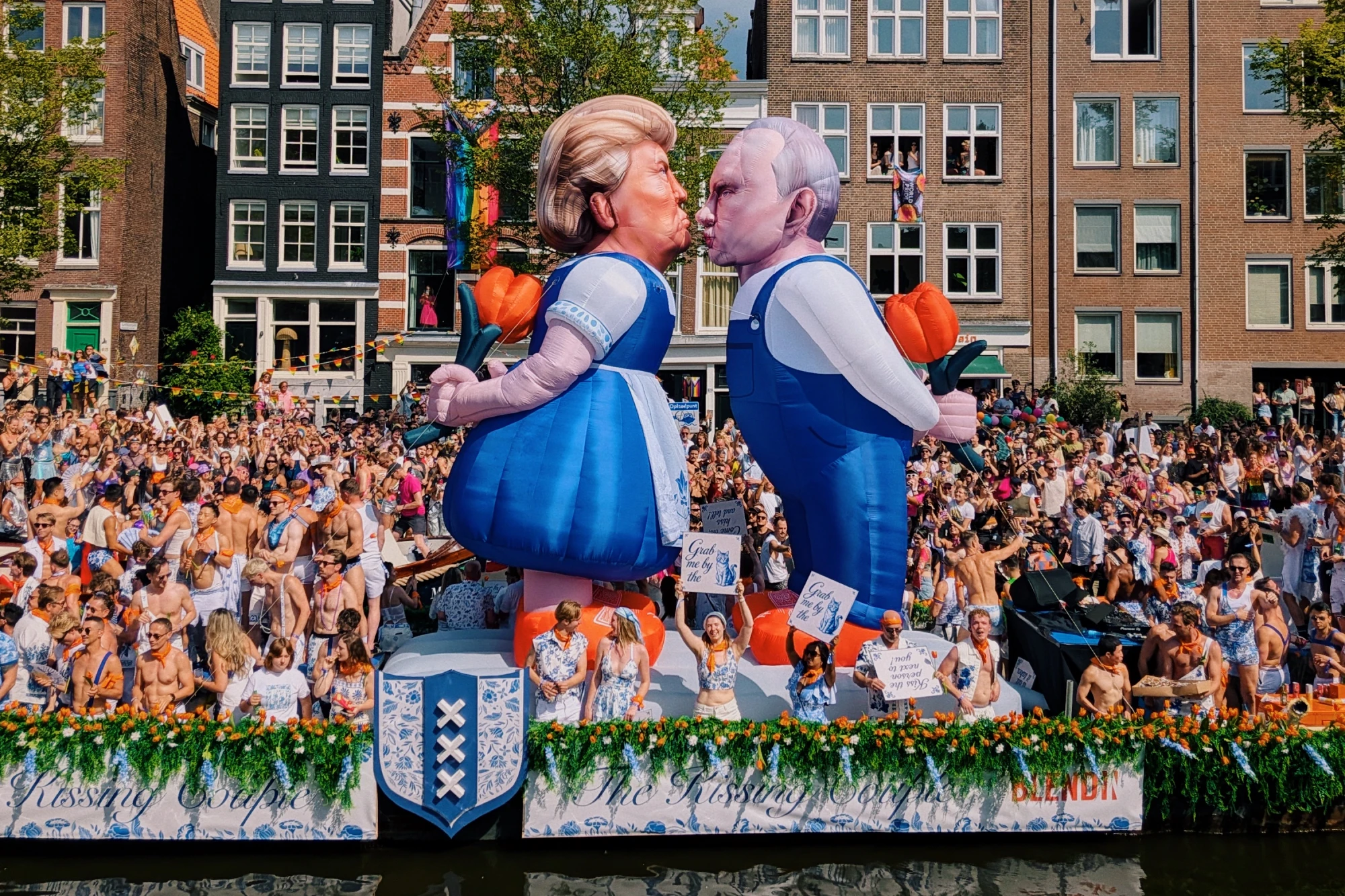 The Kissing Couple: Trump and Putin kissing in traditional Dutch outfits during World Pride Canal Parade &copy; Coupleofmen.com