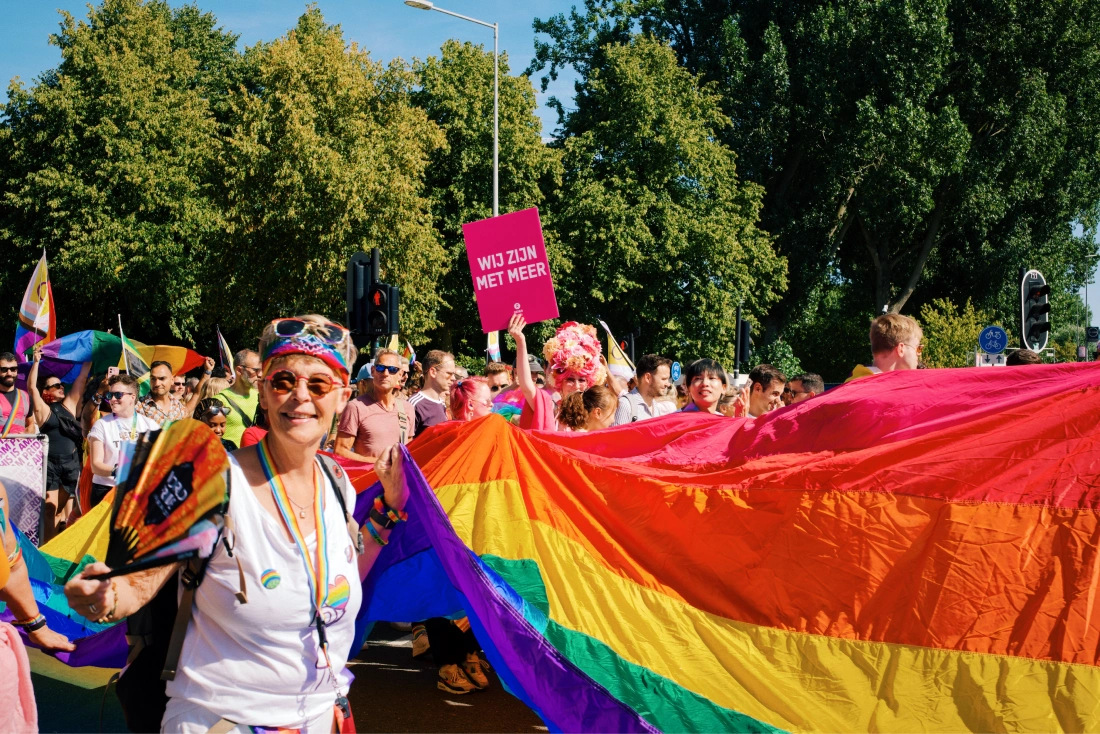 We zijn met meer - There are more of us_ Carrying the huge rainbow flag at World Pride March © Coupleofmen.com